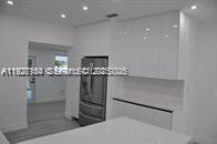 261 Northwest 46th Avenue, Unit 1 Miami, FL 33126 - Photo 3 of 10 a room with table and chandelier