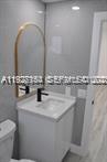 261 Northwest 46th Avenue, Unit 1 Miami, FL 33126 - Photo 5 of 10 a bathroom with a sink and a mirror