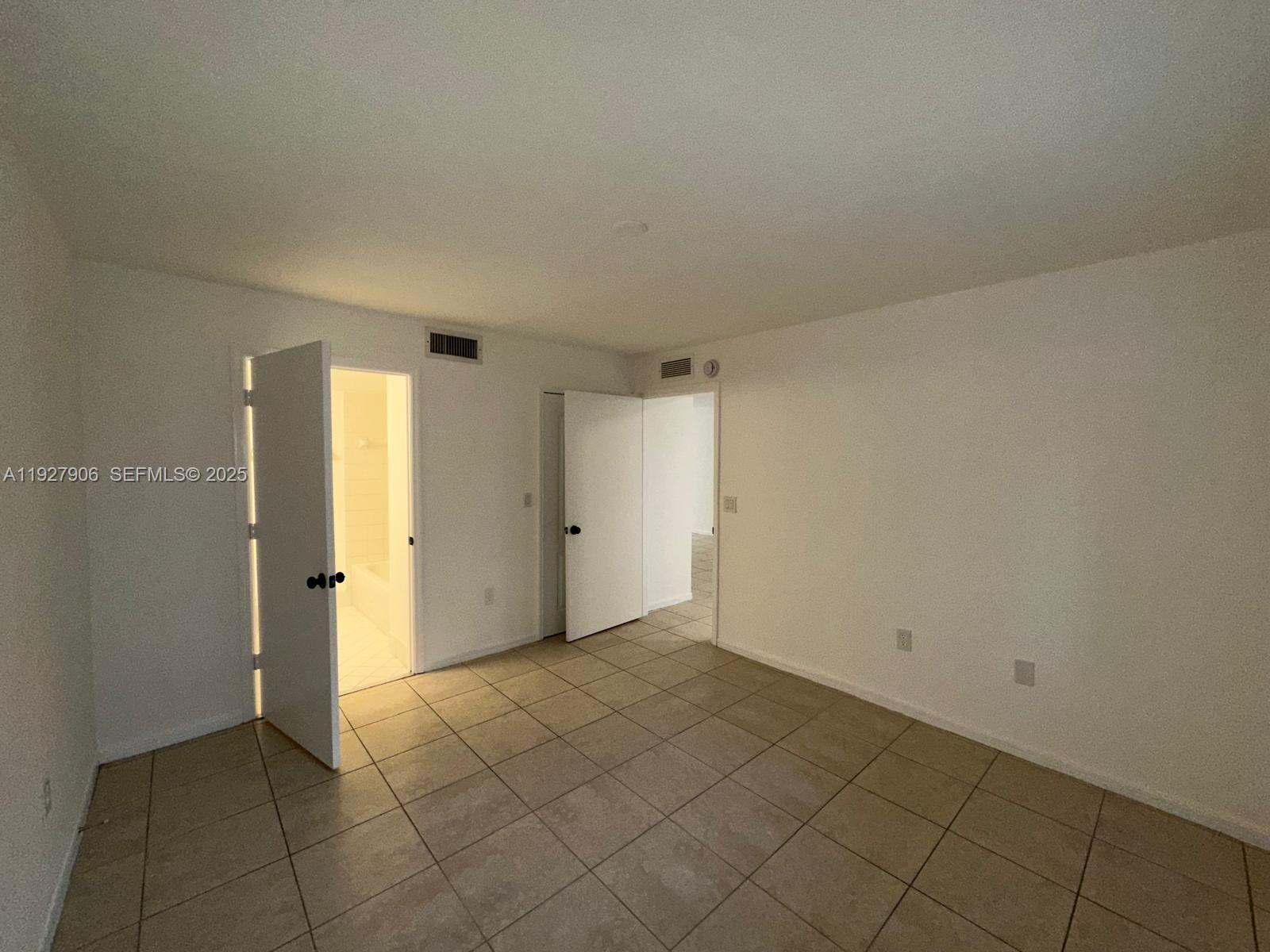 2911 Southeast 13th Road, Unit 10140 Homestead, FL 33035 - Photo 12 of 22 a view of an empty room and window