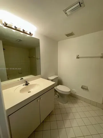 a bathroom with a sink a toilet and mirror