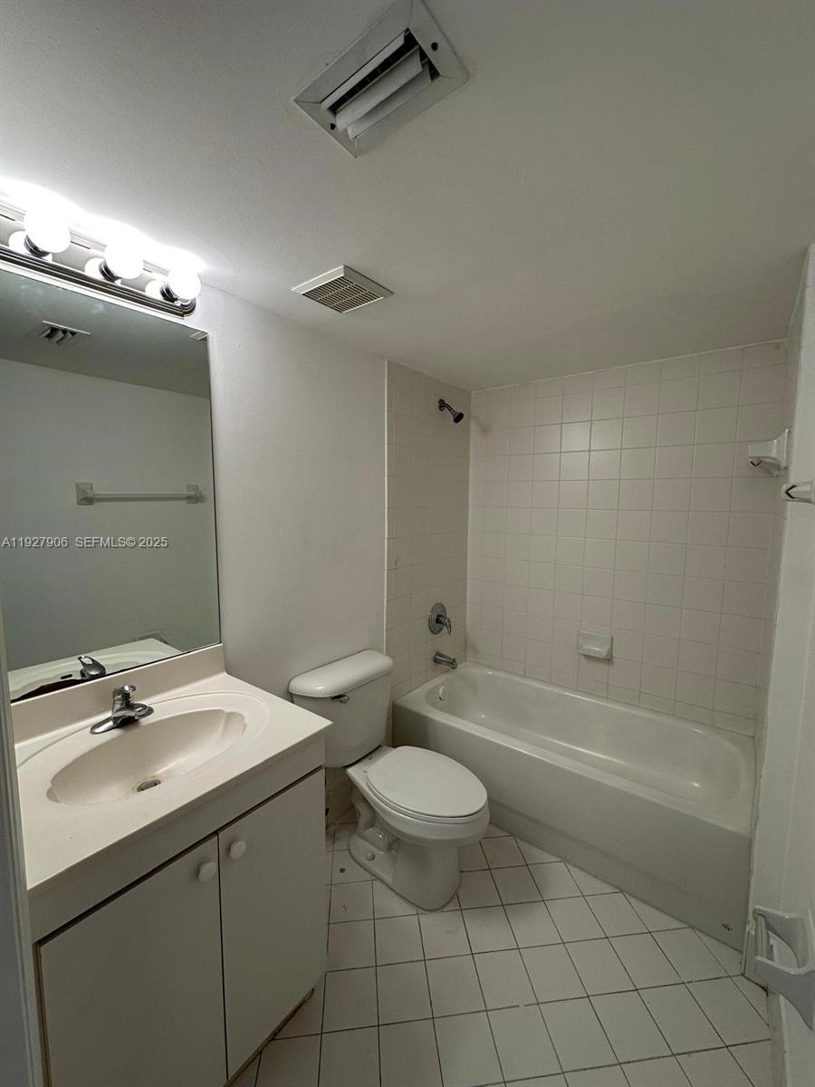 2911 Southeast 13th Road, Unit 10140 Homestead, FL 33035 - Photo 20 of 22 a bathroom with a sink a toilet and shower