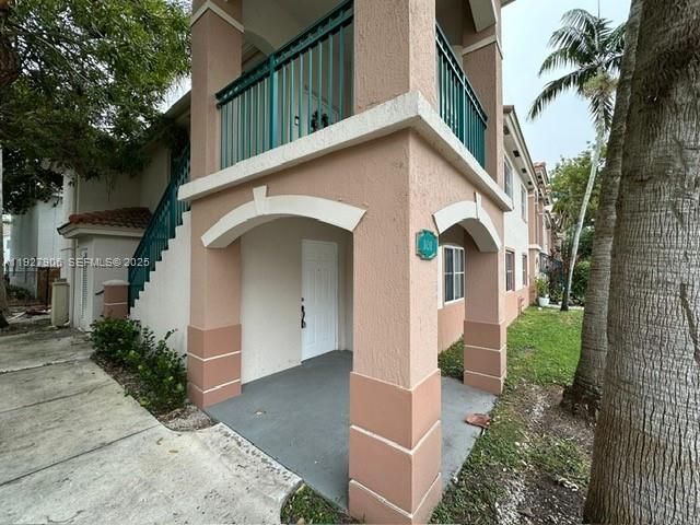 2911 Southeast 13th Road, Unit 10140 Homestead, FL 33035 - Photo 2 of 22 a front view of a house with garden