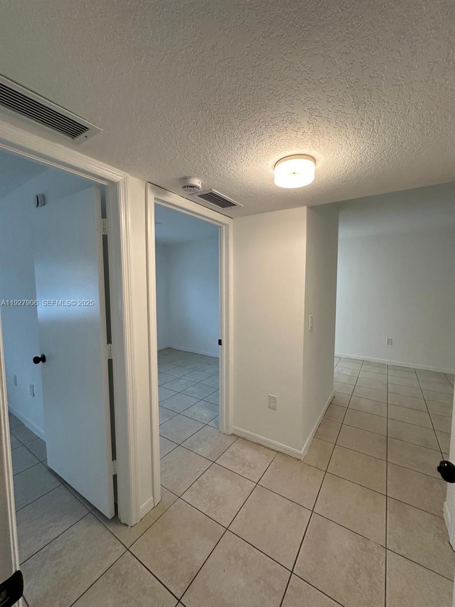 2911 Southeast 13th Road, Unit 10140 Homestead, FL 33035 - Photo 21 of 22 a view of a hallway with closet area