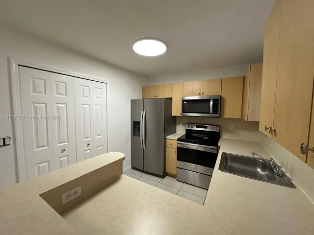 a kitchen with a refrigerator stove and microwave