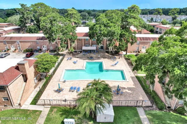 an aerial view of a house with swimming pool garden and patio