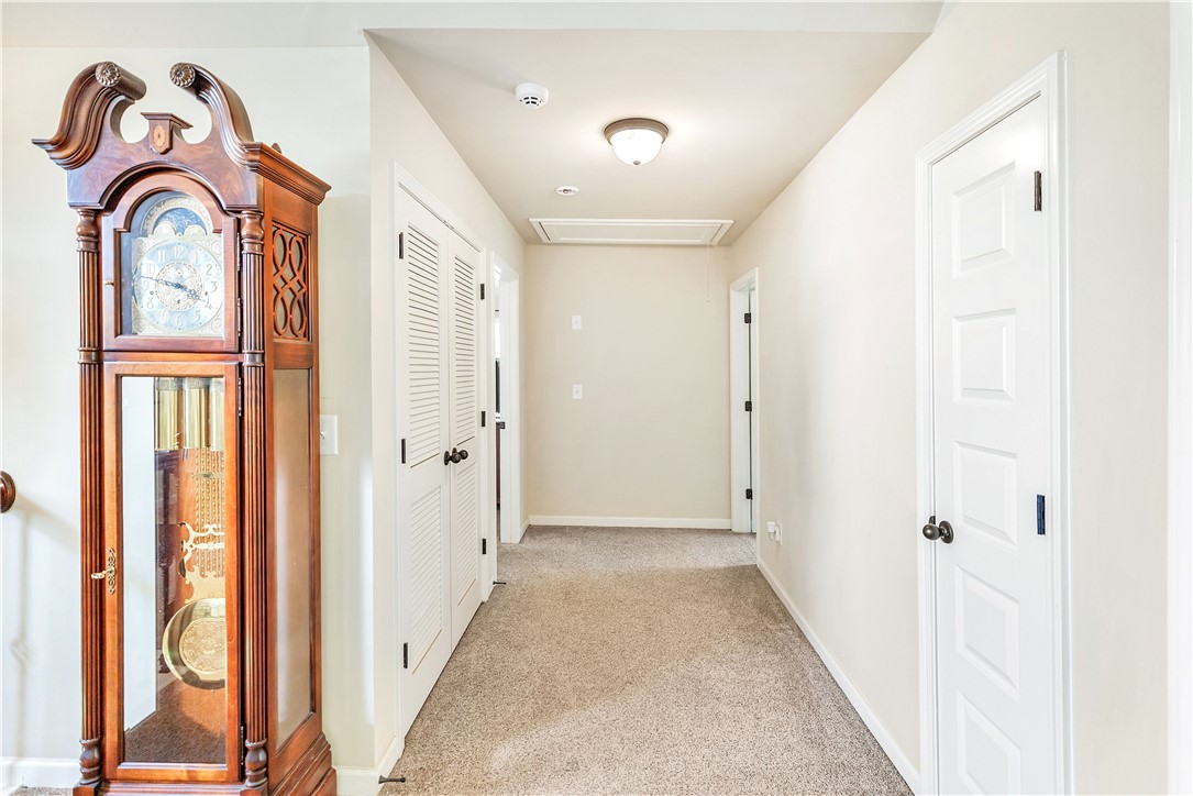144 Buckland Drive Anderson, SC 29621 - Photo 13 of 48 A well-lit corridor with soft carpeting and functional louvered closet doors offers seamless access to adjacent rooms.