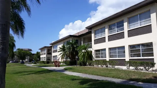 a front view of a building with a garden