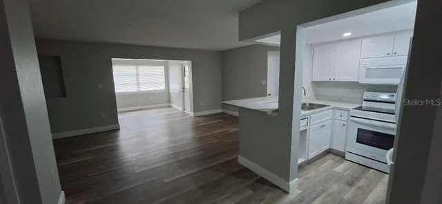 a view of a room with wooden floor