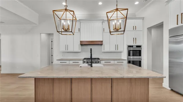 a kitchen with stainless steel appliances a sink stove and refrigerator