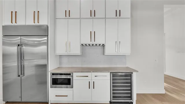 a kitchen with white cabinets and white appliances