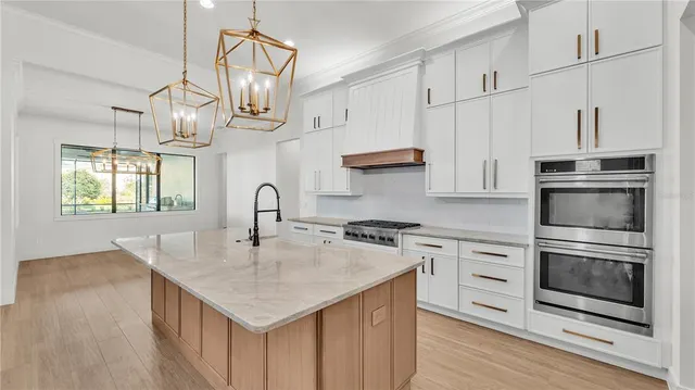 a kitchen with stainless steel appliances granite countertop a stove and a sink