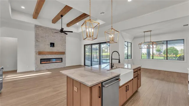 a kitchen with stainless steel appliances granite countertop a sink and stove