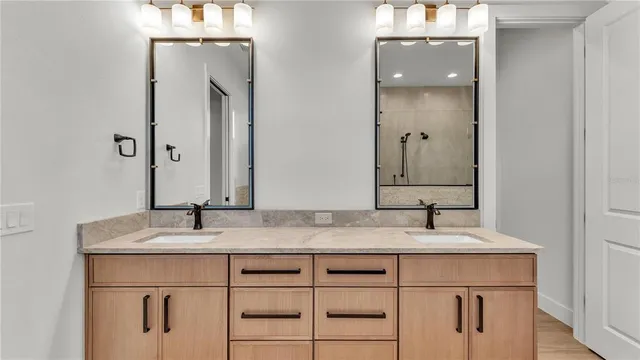 a bathroom with a double vanity sink and a mirror