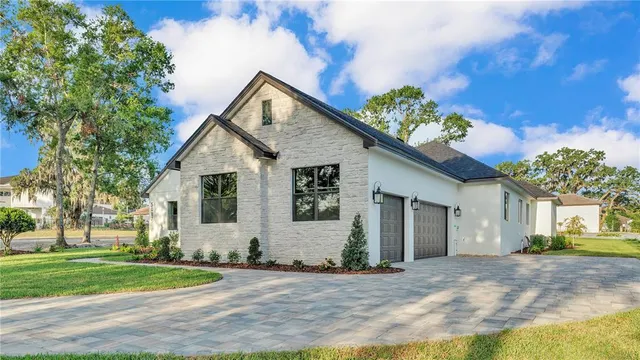 a front view of a house with a yard and a garage