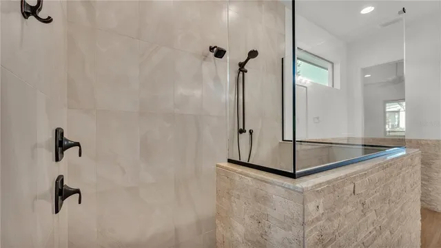 an empty room with windows and ceiling fan