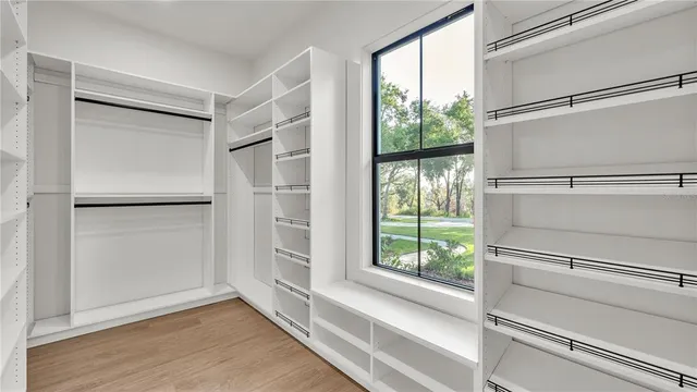 a view of walk in closet with empty racks