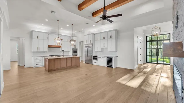 a large kitchen with stainless steel appliances kitchen island a large counter top and stainless steel appliances