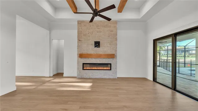 a view of room with wooden floor and a ceiling fan