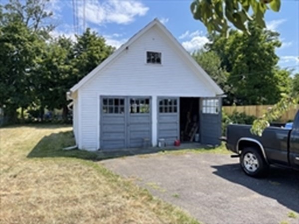 89-91 Ashley Street Springfield, MA 01105 - Photo 3 of 26 a view of a house with a yard and garage