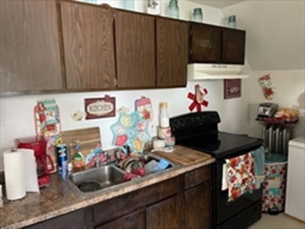 89-91 Ashley Street Springfield, MA 01105 - Photo 6 of 26 a kitchen with a stove a microwave and cabinets