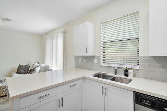 a kitchen with a sink and cabinets