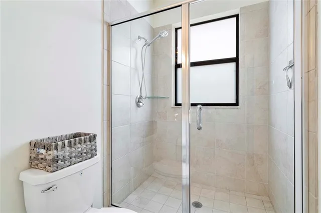 a bathroom with a shower and a sink