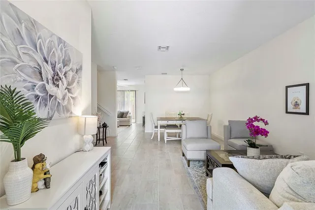 a living room with furniture and flowers