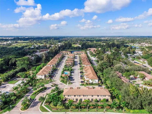 an aerial view of a house with garden space and street view