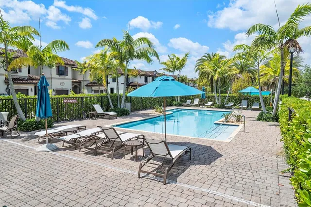 a view of a swimming pool with a chair and tables