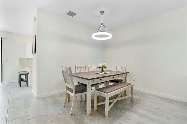a view of a dining room that has a table and chairs