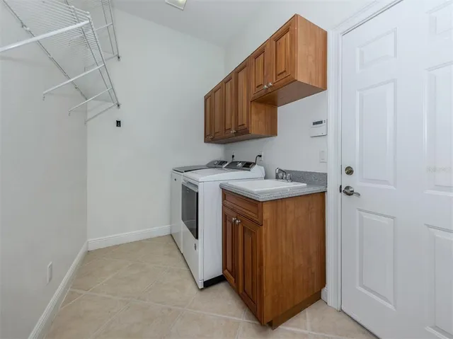 a view of a house with swimming pool and sitting area