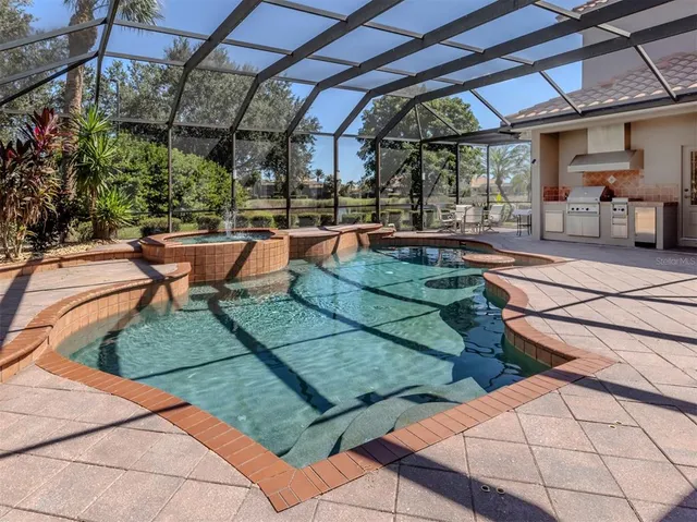 a view of a patio with chairs and table under an umbrella