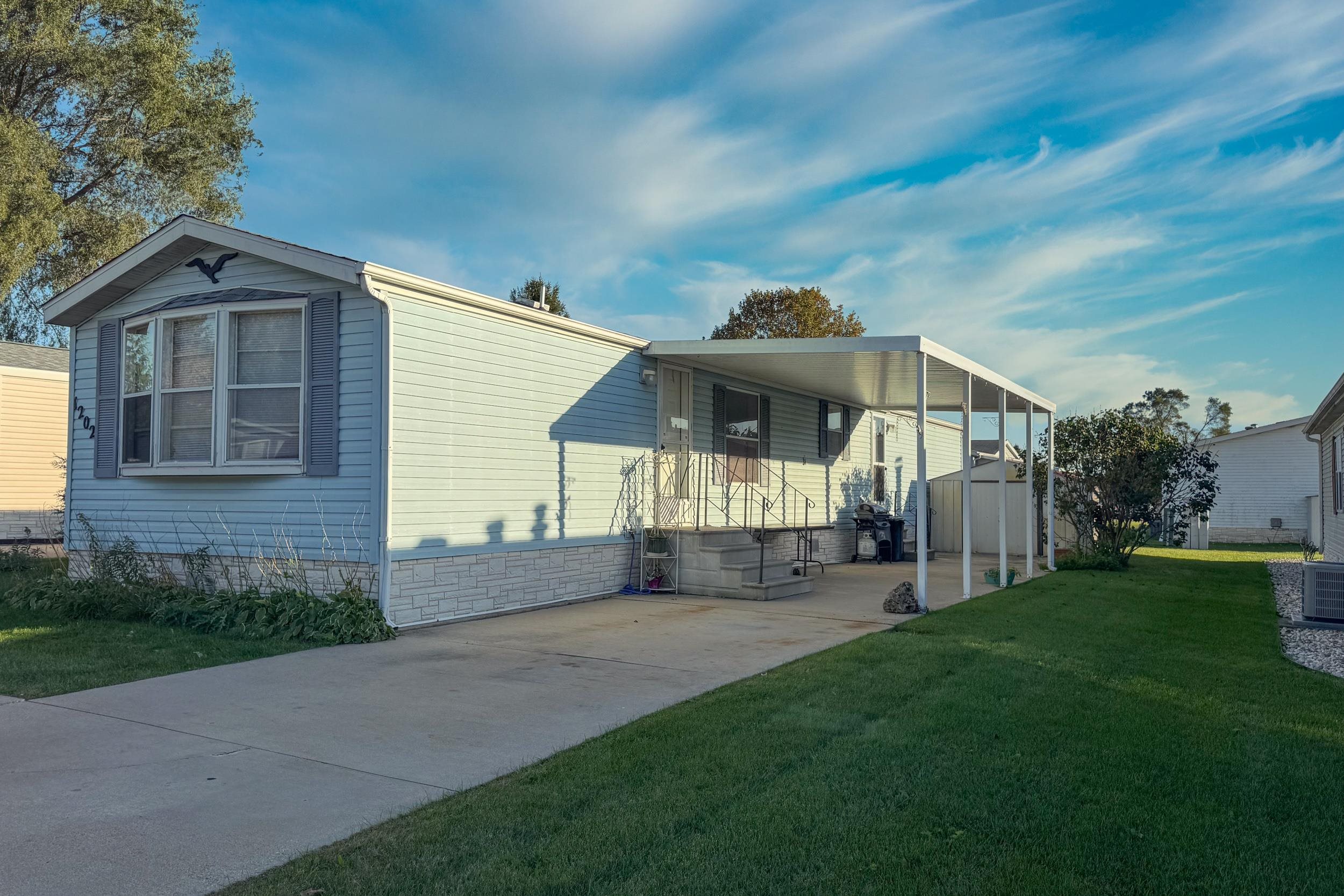 1202 Spring Circle Belvidere, IL 61008 - Photo 1 of 18 a front view of a house with a yard and pathway