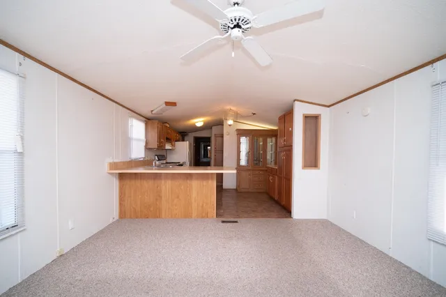 a view of a kitchen with a sink and a refrigerator