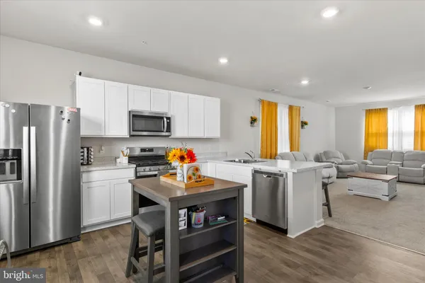 a kitchen with a refrigerator and a stove top oven