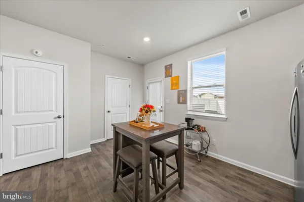 a dining room with furniture and wooden floor