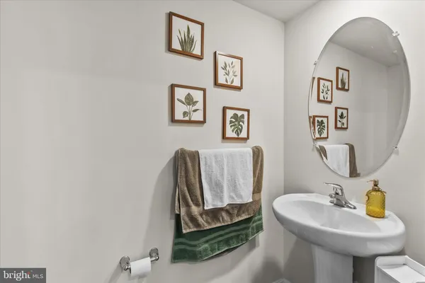 a bathroom with a sink mirror and toilet