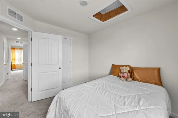 a bedroom with a bed and a painting