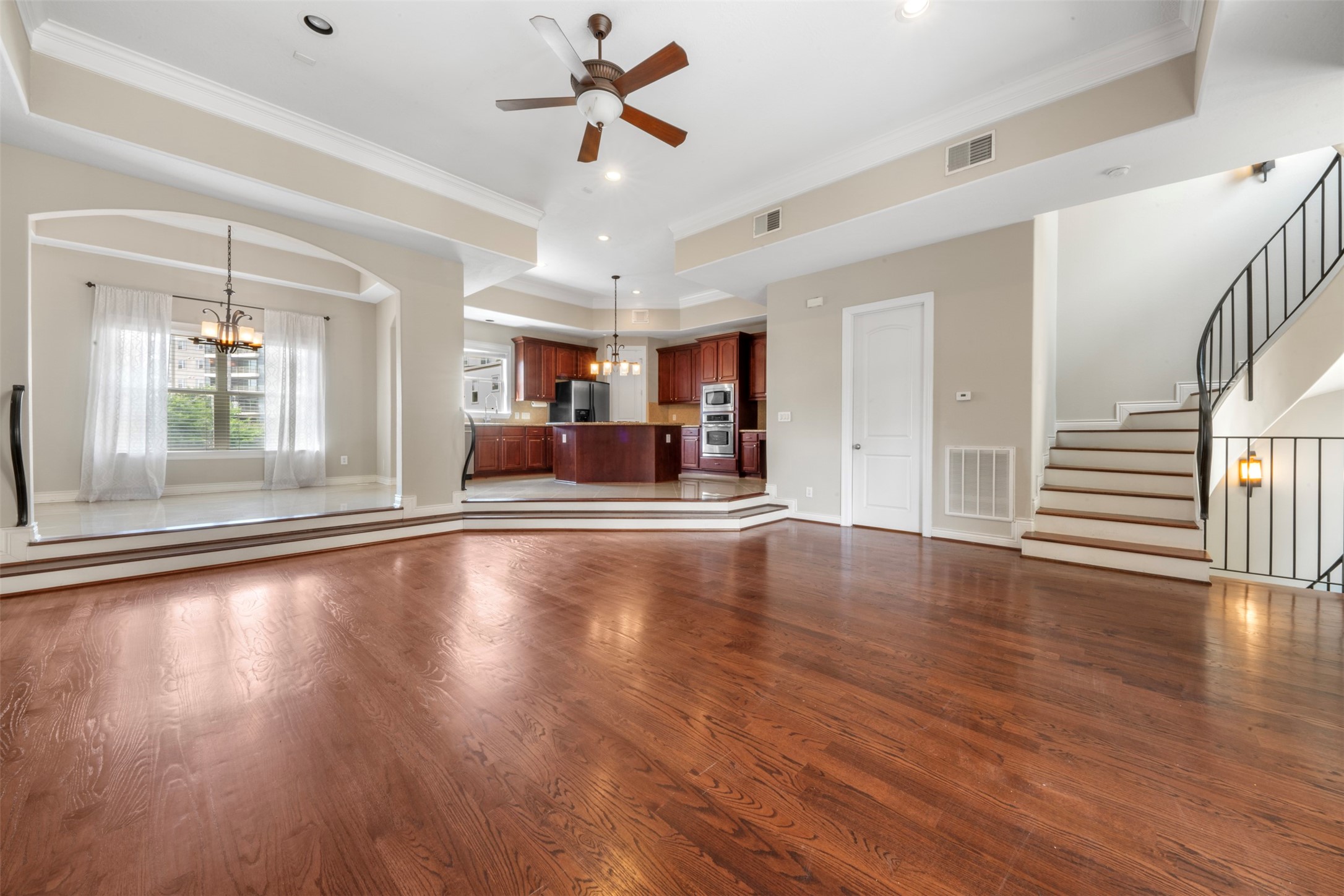 a view of a livingroom with hardwood floor and a ceiling fan