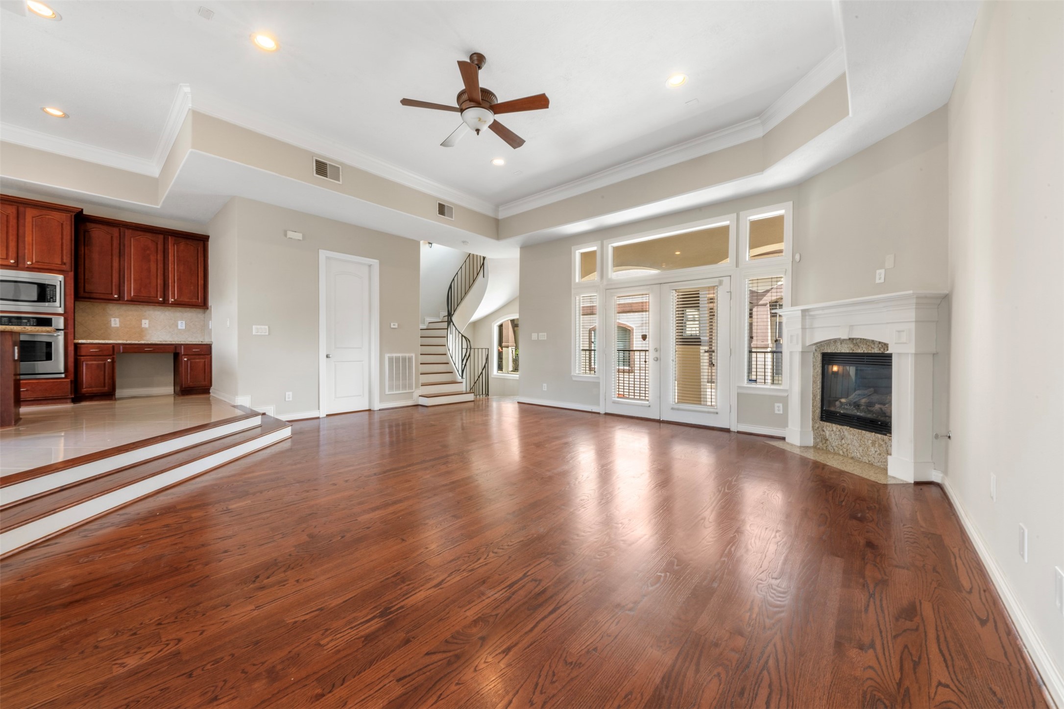 6524 Calder Street Houston, TX 77007 - Photo 2 of 28 an empty room with fireplace wooden floor and windows