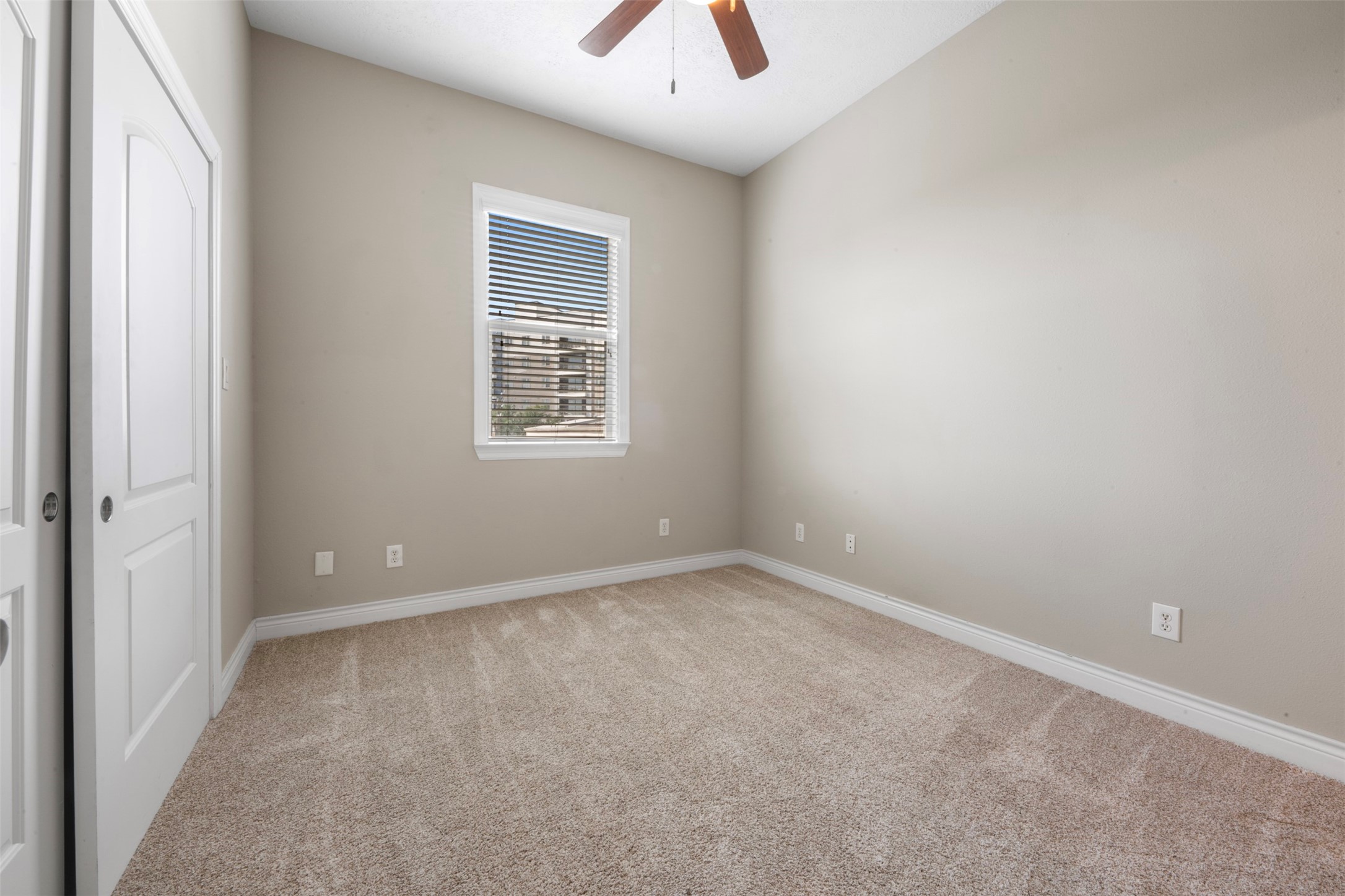 6524 Calder Street Houston, TX 77007 - Photo 23 of 28 an empty room with a window and a chandelier fan