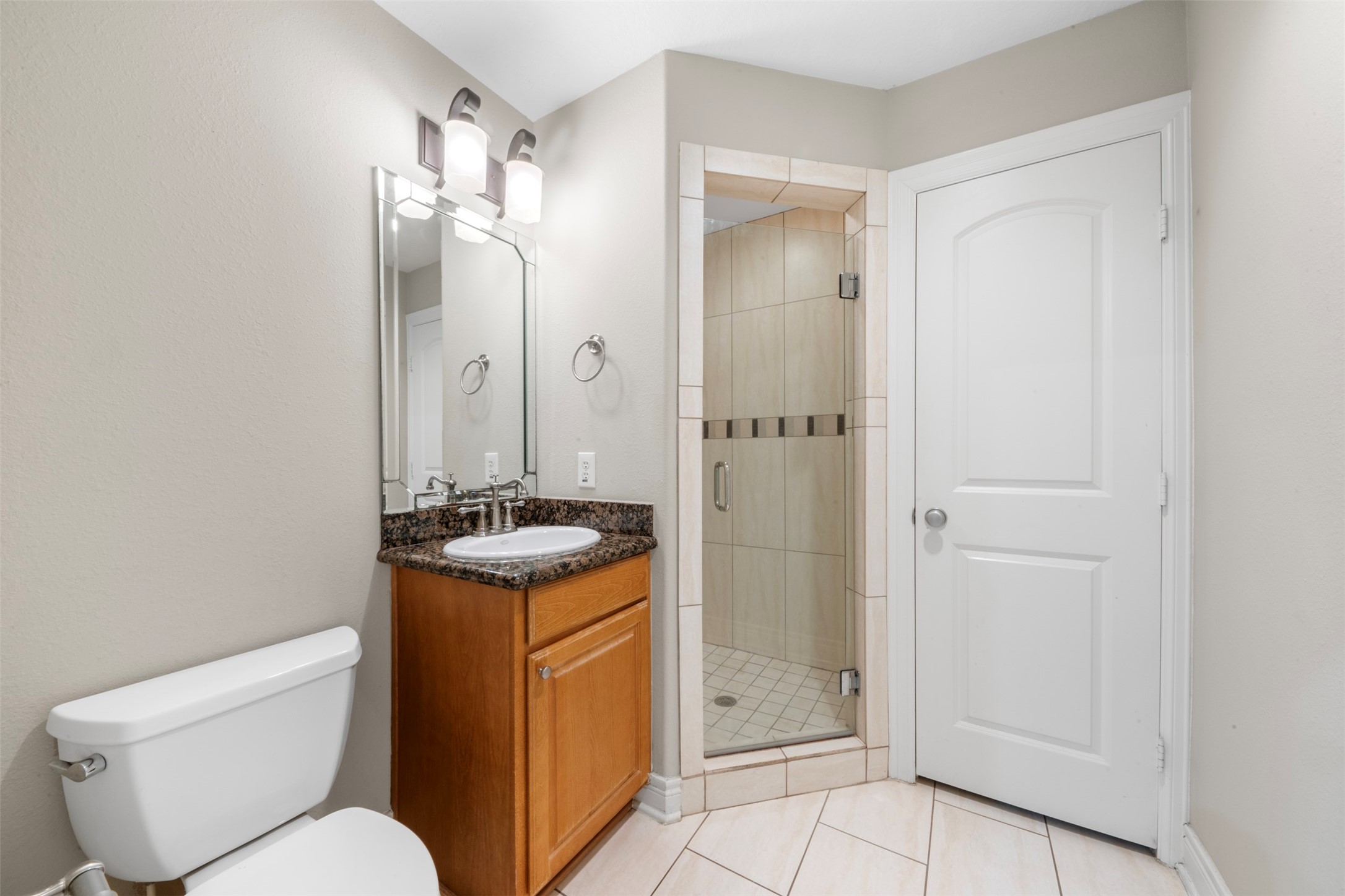 6524 Calder Street Houston, TX 77007 - Photo 24 of 28 a bathroom with a granite countertop toilet sink and shower
