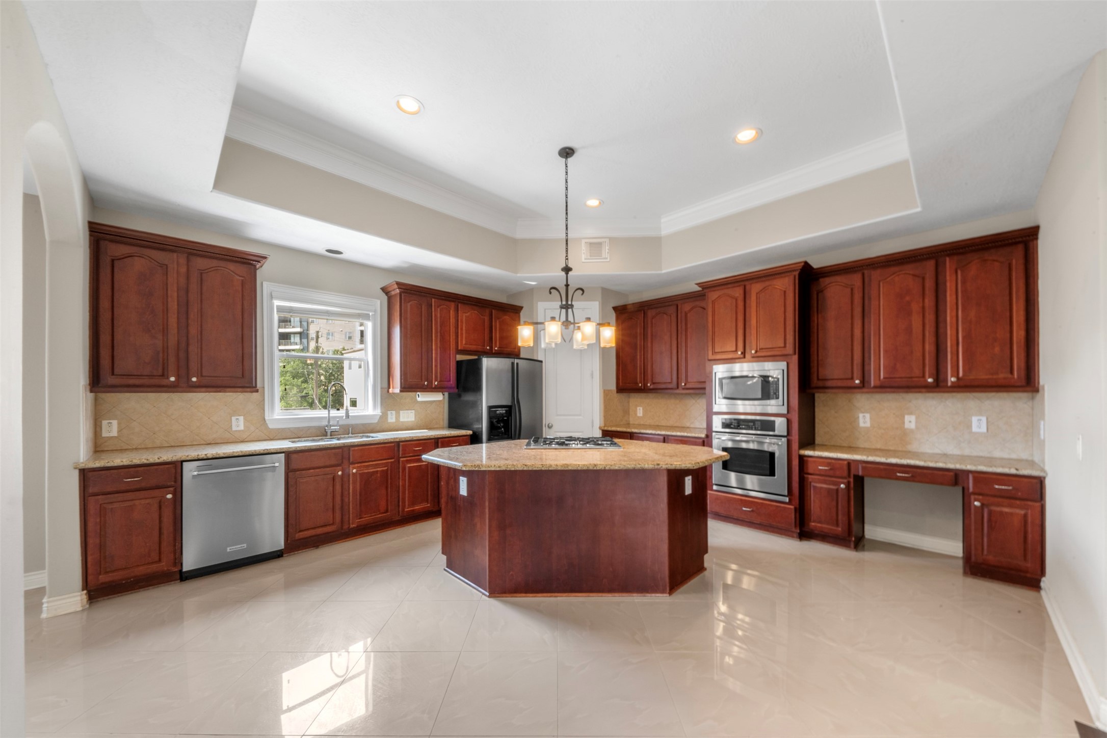 6524 Calder Street Houston, TX 77007 - Photo 9 of 28 a large kitchen with stainless steel appliances kitchen island granite countertop a stove sink and cabinets