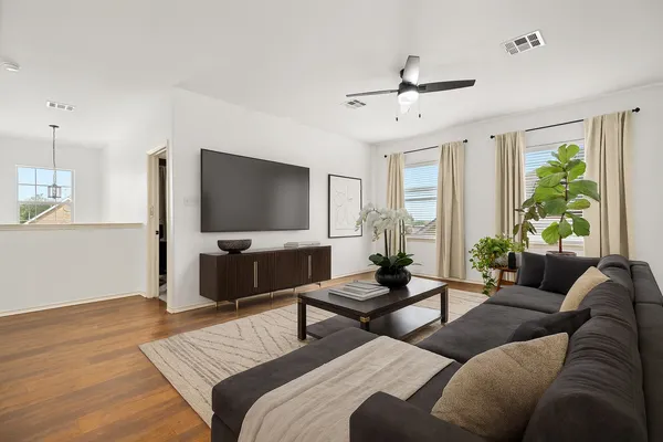 a living room with furniture and a flat screen tv