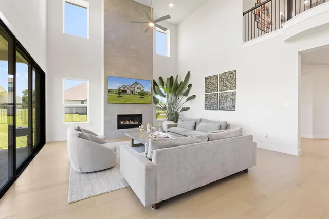 a living room with furniture a fireplace and a potted plant