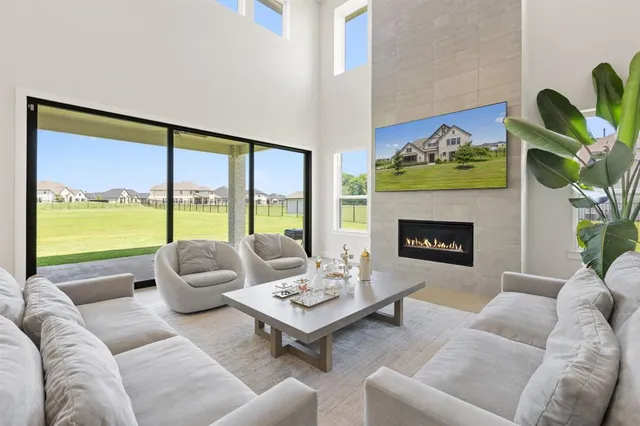 a living room with furniture fireplace and window