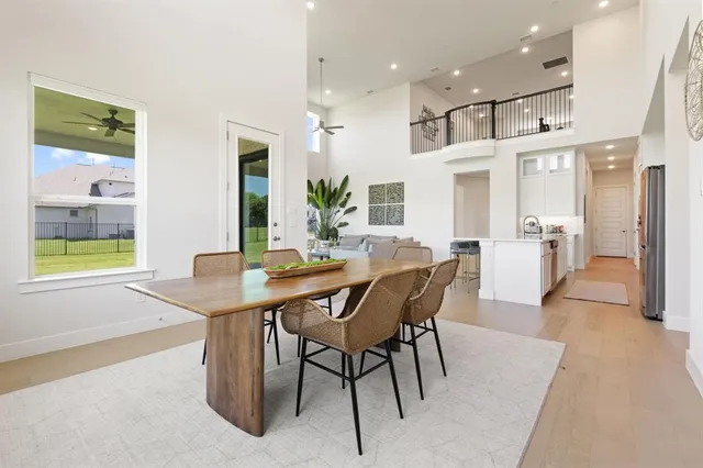a view of a dining room with furniture and a chandelier