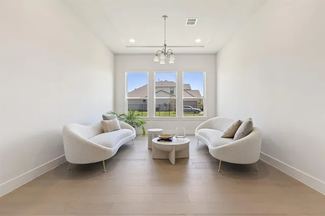 a living room with furniture and a chandelier