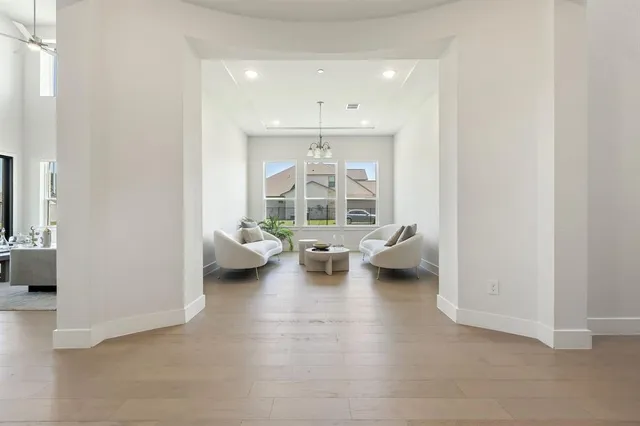 a living room with furniture and a chandelier