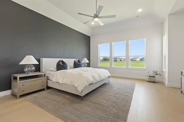 a spacious bedroom with a bed and a large window